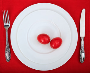Easter eggs on a plate on red tablecloth