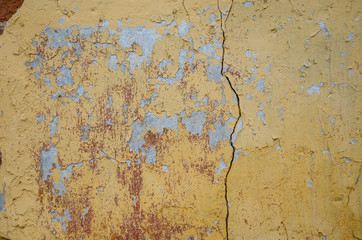 Abstract background of cracked yellow paint 