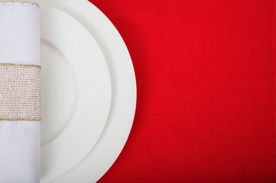 Formal table setting on red tablecloth