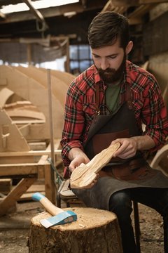 Carpenter making wooden spoon