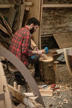 Carpenter making wooden spoon