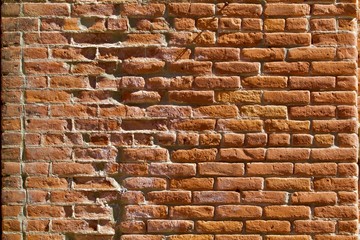 Nineteenth century red brick wall worn by time