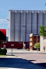 Midwest town street with grain bins in background