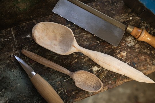 Close-up of worktool and wooden spoon on table