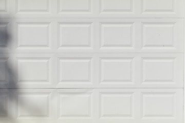 White metal wall with a pattern of rows of squares