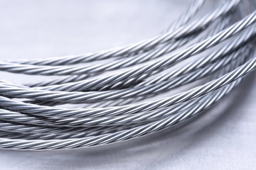 Steel wire rope closeup on grey metal surface