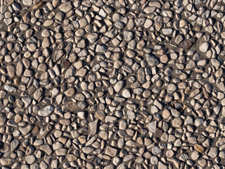 The wall is covered with pebbles of gray shades
