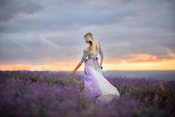 Woman walk in the field of lavender