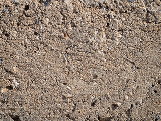 Rough plaster with beige cracks