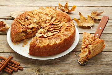 Apple cake in plate on grey wooden table