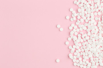 Sweetener tablets on pink background