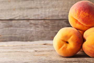Naklejka na ściany i meble Ripe peaches fruit on grey wooden table