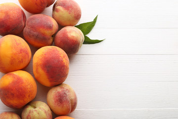 Ripe peaches fruit on white wooden table