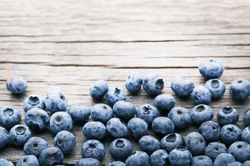 Ripe blueberries on grey wooden table