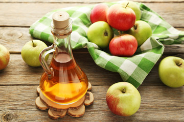 Naklejka na ściany i meble Apple vinegar in glass bottle on grey wooden table