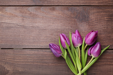 Bouquet of tulips on brown wooden table