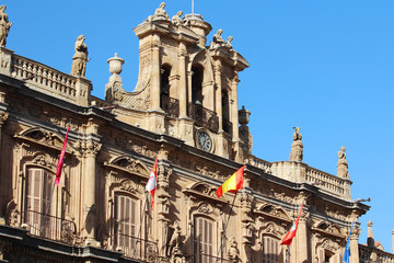 Fototapeta na wymiar A Spanish flag at facade, The Plaza Mayor, Salamanca, Spain 