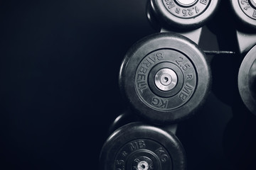 Obraz premium Dumbbells. A series of iron dumbbells in the gym. Copy space