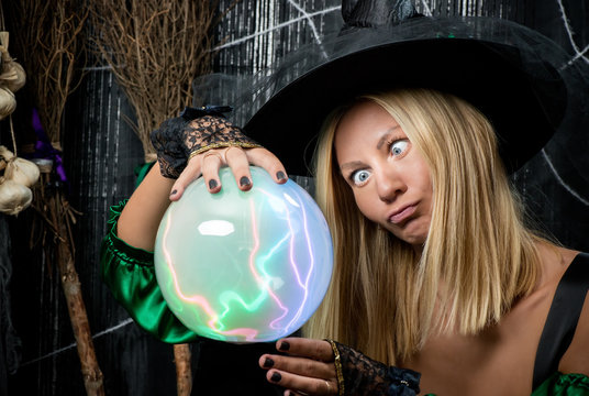 emotional witch looks into a magic ball