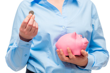 Close-up of businesswoman's hands with a pink piggy bank