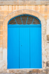 Traditional wooden painted blue door in Malta