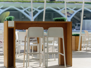 Outdoor restaurant dining table in sun in Valencia city of scince and arts for tow persons. Front view1
