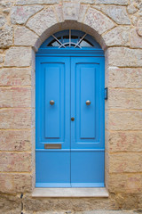 Fototapeta na wymiar Traditional wooden painted blue door in Malta