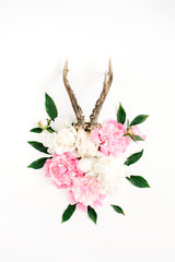 Beautiful pink and white peony flowers bouquet and goat horns on white background. Flat lay, top view modern stylish hipster background.