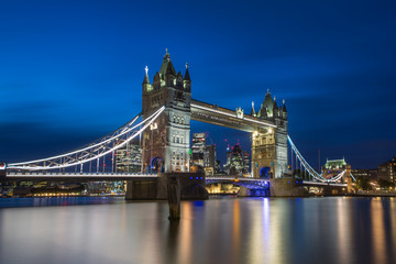 Famous Tower Bridge in the evening with blue sky and reflex on water, London, England