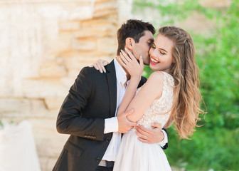 Bride and groom at wedding ceremony by the old cathedral