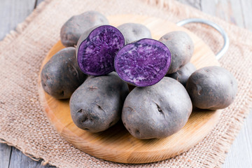 Fototapeta na wymiar Purple sweet potato on a wooden table