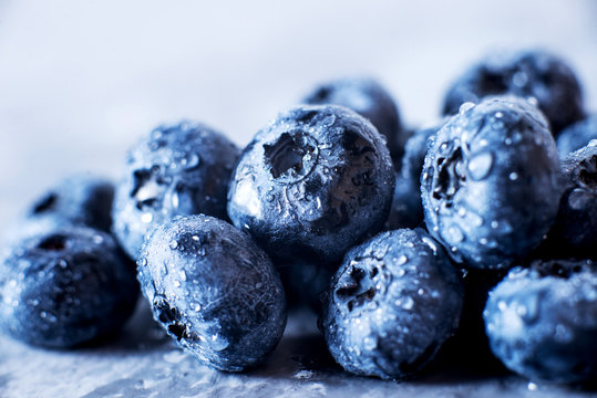 Contrast macro photo food, summer fresh juicy ripe berries, blueberries on gray background