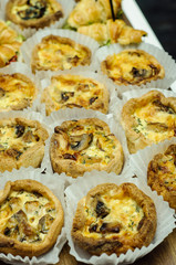 Delicious pies filled with meat and vegetables on wooden