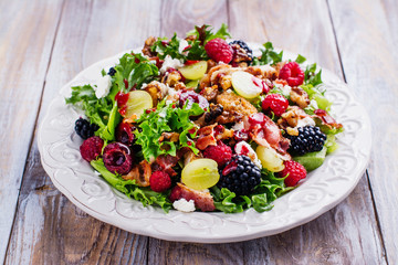 Delicious summer salad with mix of berries, nuts, feta cheese and bacon. Space for text