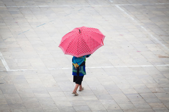 hmong girl with big red umbrella in Sa Pa, Lao Cai, Vietnam