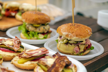 Burger on wooden table picnic. Vintage home made burger. Fast food meal. American food.