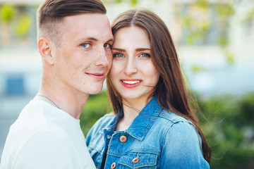 Fototapeta premium Young couple in love hug each other in city