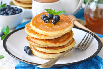 Homemade vanilla punkcakes with syrup and blueberries for breakfast. Good morning!