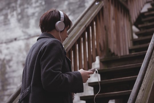 Woman listening to music on headphones
