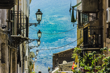 Building and street lamps of the town of monreale