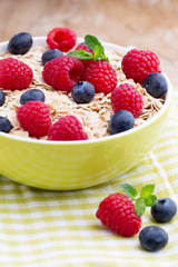 Oatmeal porridge with berries. Raspberries and blueberries.