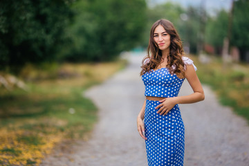 Fashion woman portrait of young pretty trendy girl in retro style polka-dotted dress posing at the...