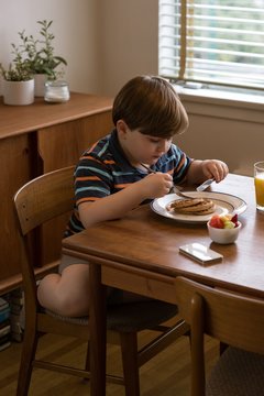 Cute boy having breakfast