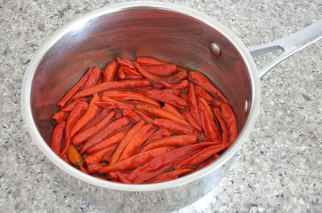 Hot red chillies cooked in a metal pot