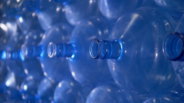 Macro view on necks of empty water cooler bottles. 