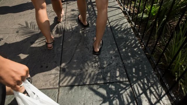 Following Couple Walk Legs Only on Las Vegas Strip. looking down at the sidewalk while people walk through the crowds on the Las Vegas Strip during daytime

