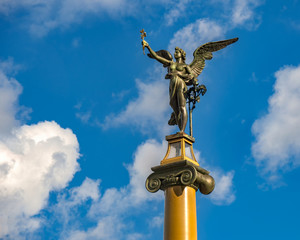 Fototapeta premium Cechuv Bridge in Prague - A Historic Bronze Statue Of a Standing Angel With Stretched out Wings
