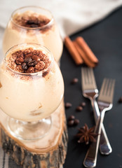 luxurious dessert tiramisu in a cognac glasses, the concept of sweet life 