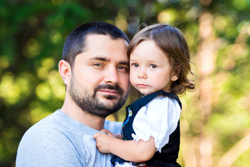 Fototapeta premium happy family and father's day. child daughter kissing and hugging dad