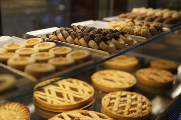 Delicious cakes on the shelf in confectionery